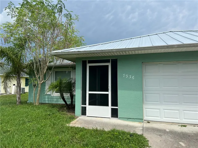 a view of a house with a large window and a yard