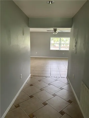 a view of an empty room and a window
