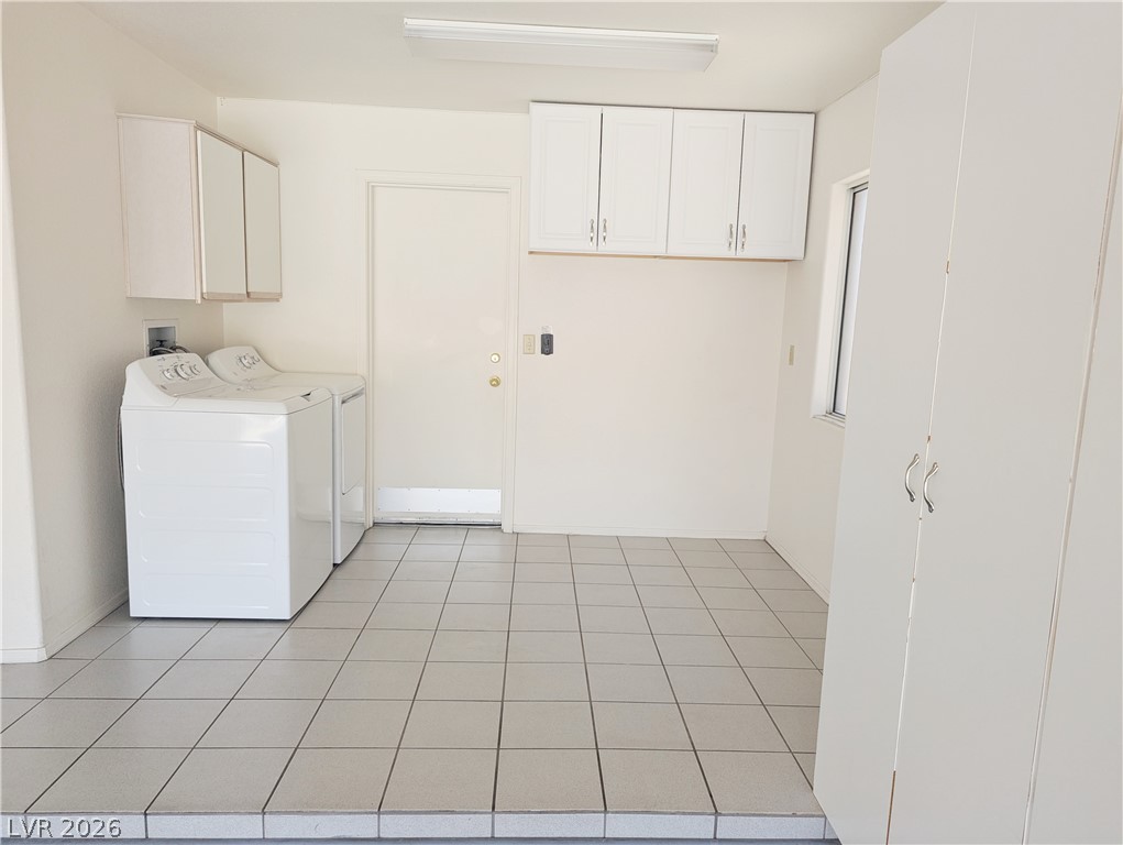 9433 Quail Ridge Drive Las Vegas, NV 89134 - Photo 18 of 23 Functional laundry area with storage cabinets offers seamless home utility.