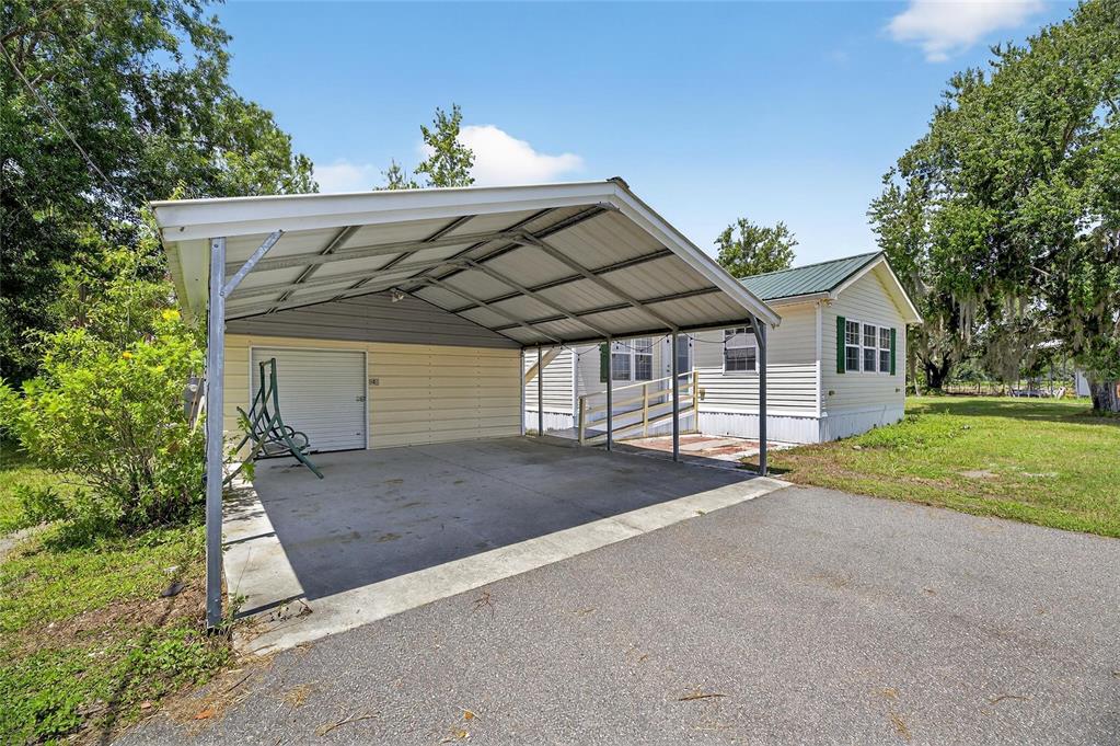 6250 Green Pond Road Polk City, FL 33868 - Photo 11 of 96 a view of a house with a yard and garage