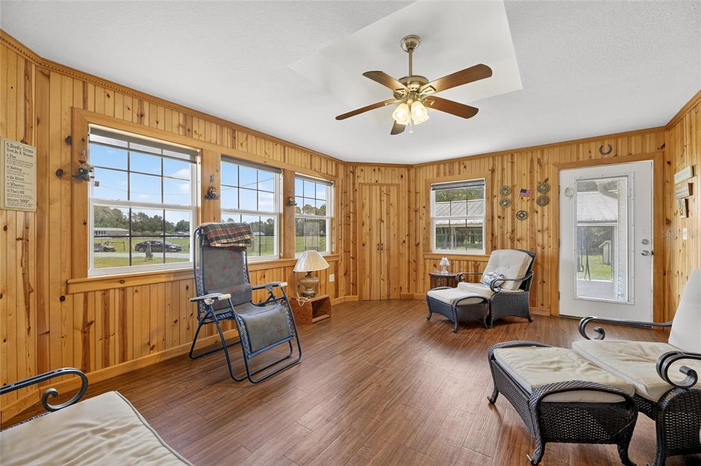 6250 Green Pond Road Polk City, FL 33868 - Photo 17 of 96 a living room with furniture and floor to ceiling windows