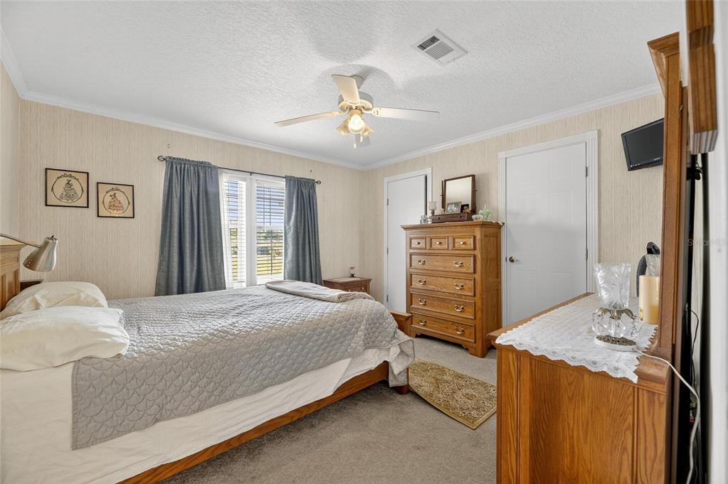 6250 Green Pond Road Polk City, FL 33868 - Photo 29 of 96 a bedroom with a bed and a dresser