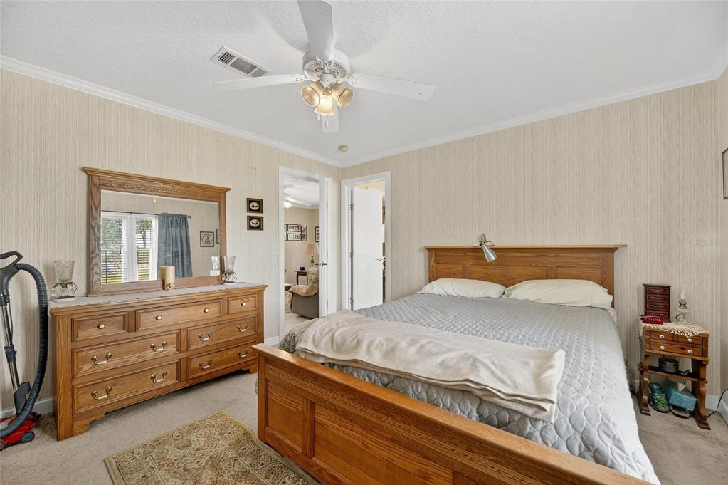 6250 Green Pond Road Polk City, FL 33868 - Photo 31 of 96 a bedroom with a bed and a dresser