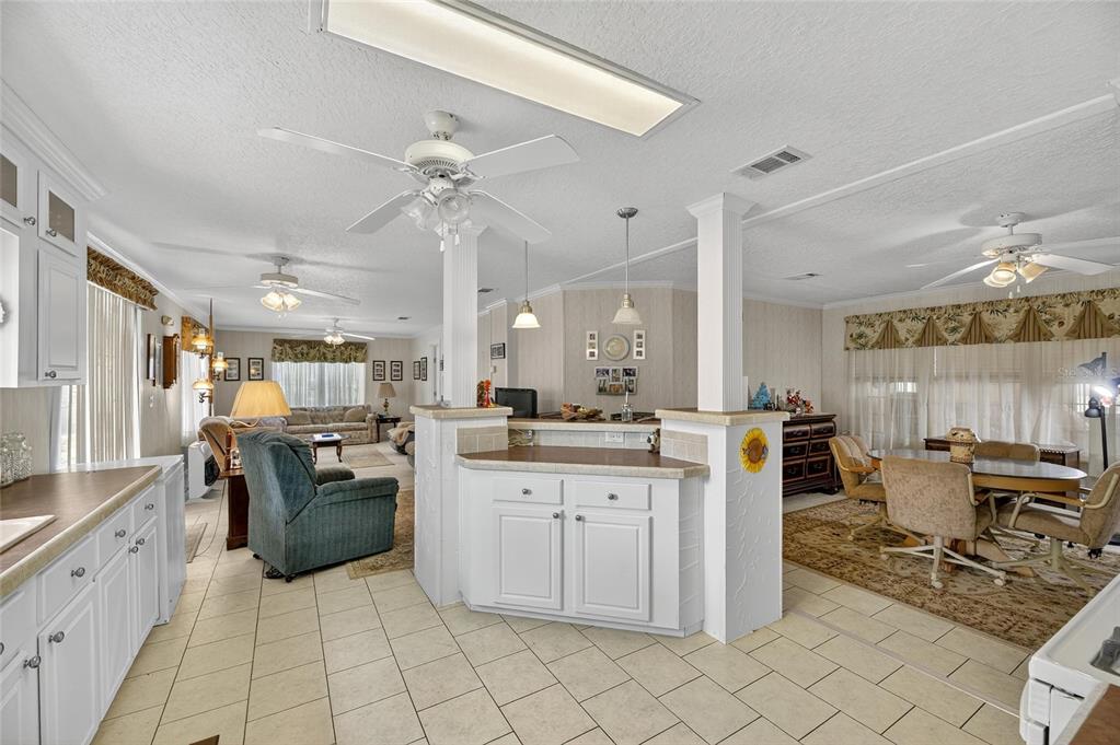 6250 Green Pond Road Polk City, FL 33868 - Photo 53 of 96 a large kitchen with kitchen island a counter top space appliances and cabinets