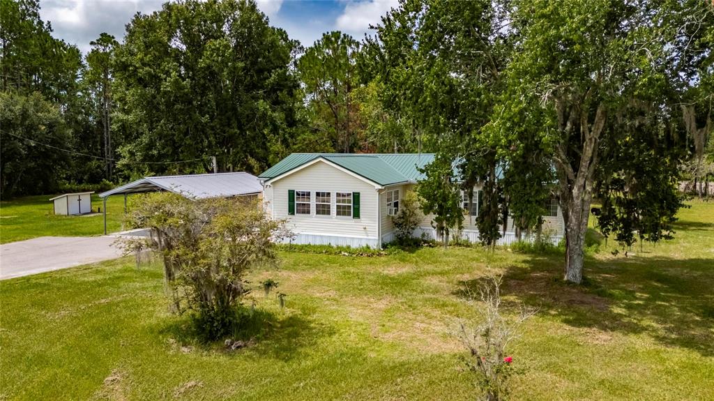6250 Green Pond Road Polk City, FL 33868 - Photo 69 of 96 a front view of a house with a yard