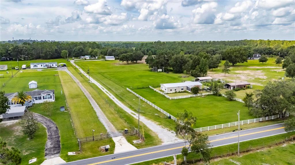 6250 Green Pond Road Polk City, FL 33868 - Photo 8 of 96 a view of a swimming pool with a garden and lake view
