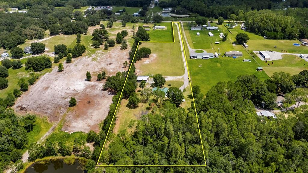 6250 Green Pond Road Polk City, FL 33868 - Photo 95 of 96 an aerial view of residential houses with outdoor space and parking