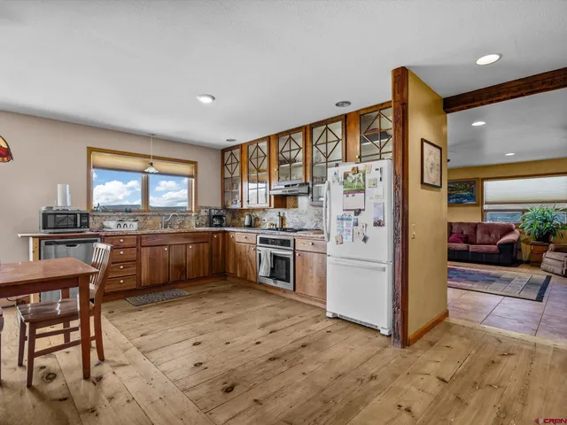 a kitchen with stainless steel appliances kitchen island granite countertop a stove a sink and a refrigerator