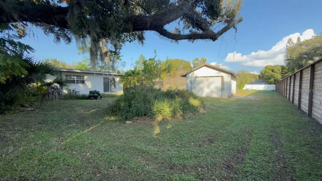 a backyard of a house with table and chairs