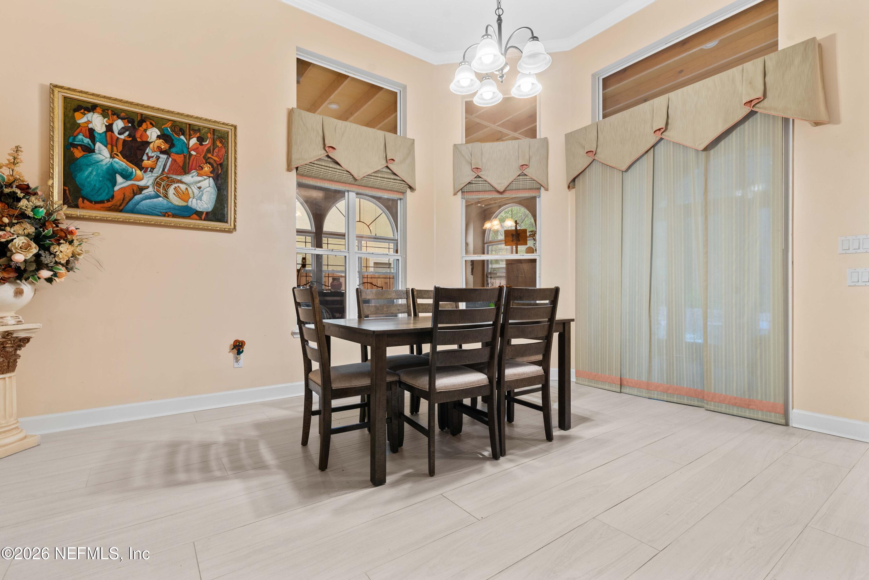 5983 Wakulla Springs Road Jacksonville, FL 32258 - Photo 11 of 31 a view of a dining room with furniture a chandelier and a window