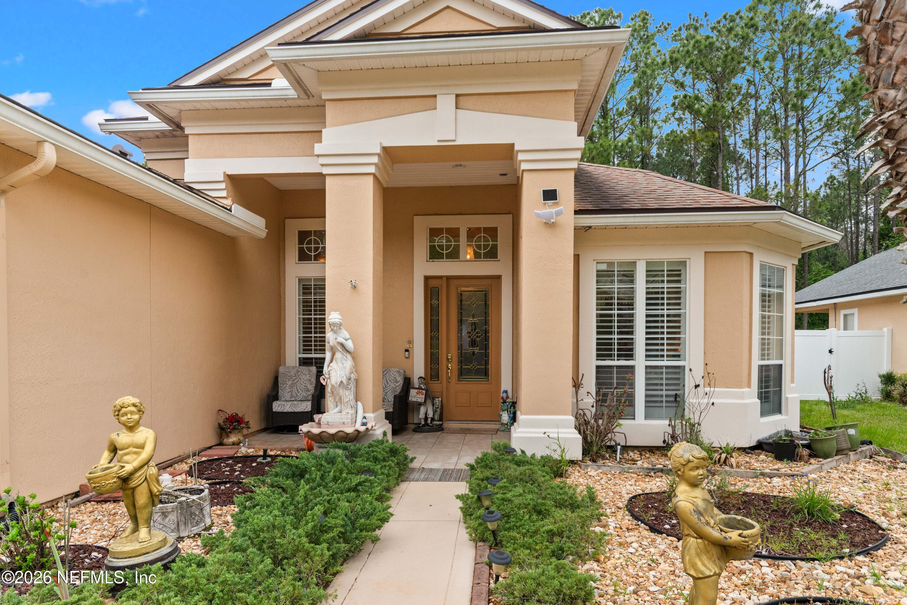 5983 Wakulla Springs Road Jacksonville, FL 32258 - Photo 2 of 31 a front view of a house with garden