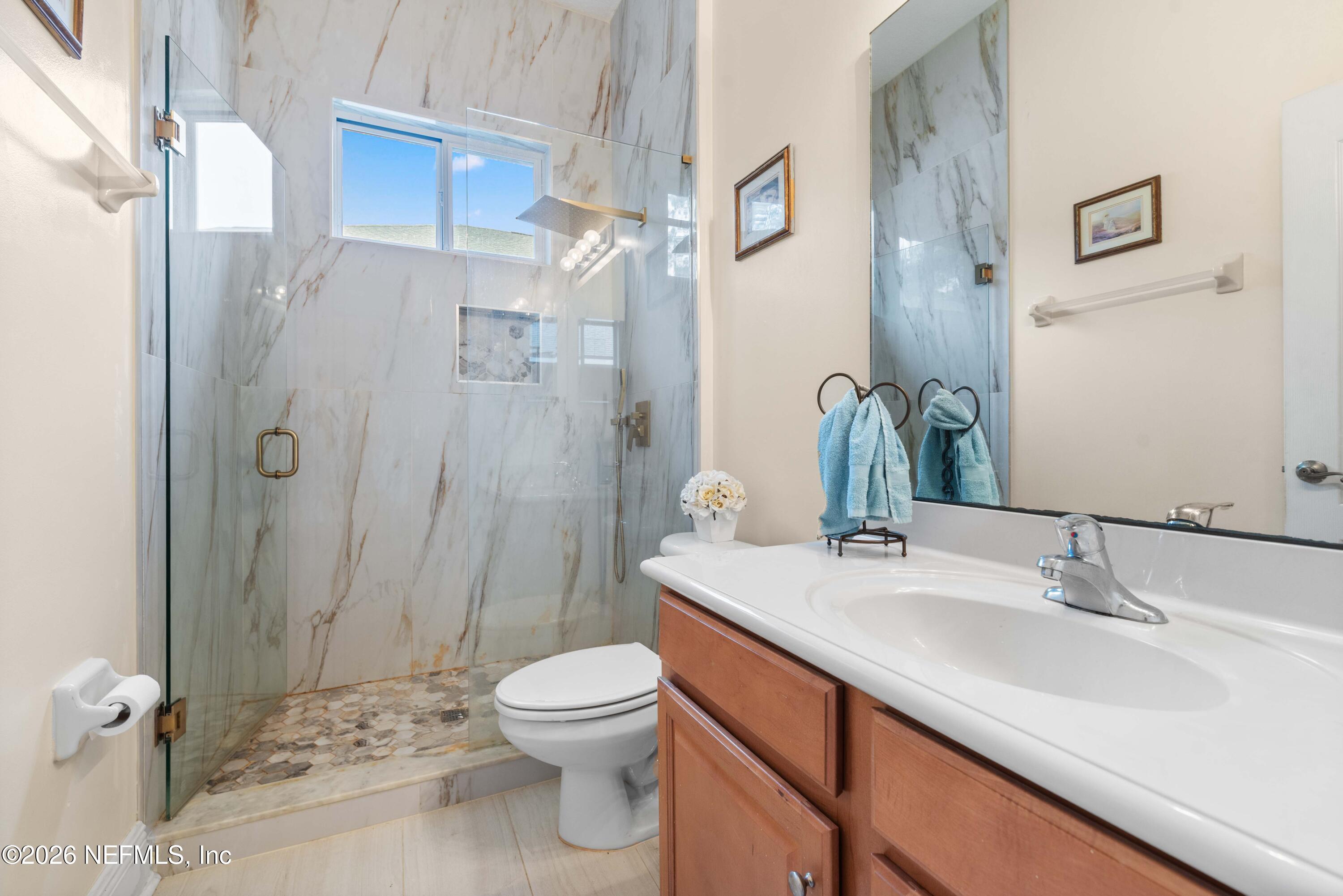 5983 Wakulla Springs Road Jacksonville, FL 32258 - Photo 26 of 31 a bathroom with a sink a toilet and shower