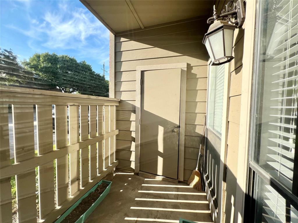 2105 Count Fleet Drive, Unit 207 Arlington, TX 76011 - Photo 16 of 17 a view of balcony with wooden floor and door
