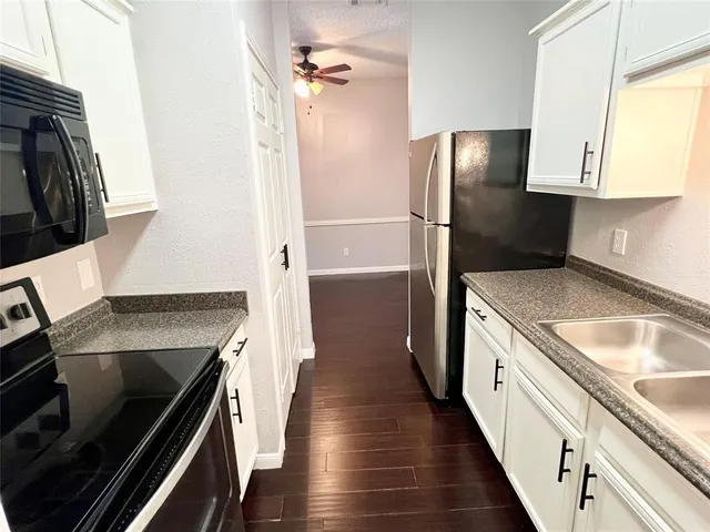 a kitchen with a sink stove and refrigerator