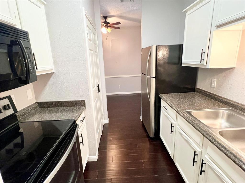 2105 Count Fleet Drive, Unit 207 Arlington, TX 76011 - Photo 8 of 17 a kitchen with a sink stove and refrigerator