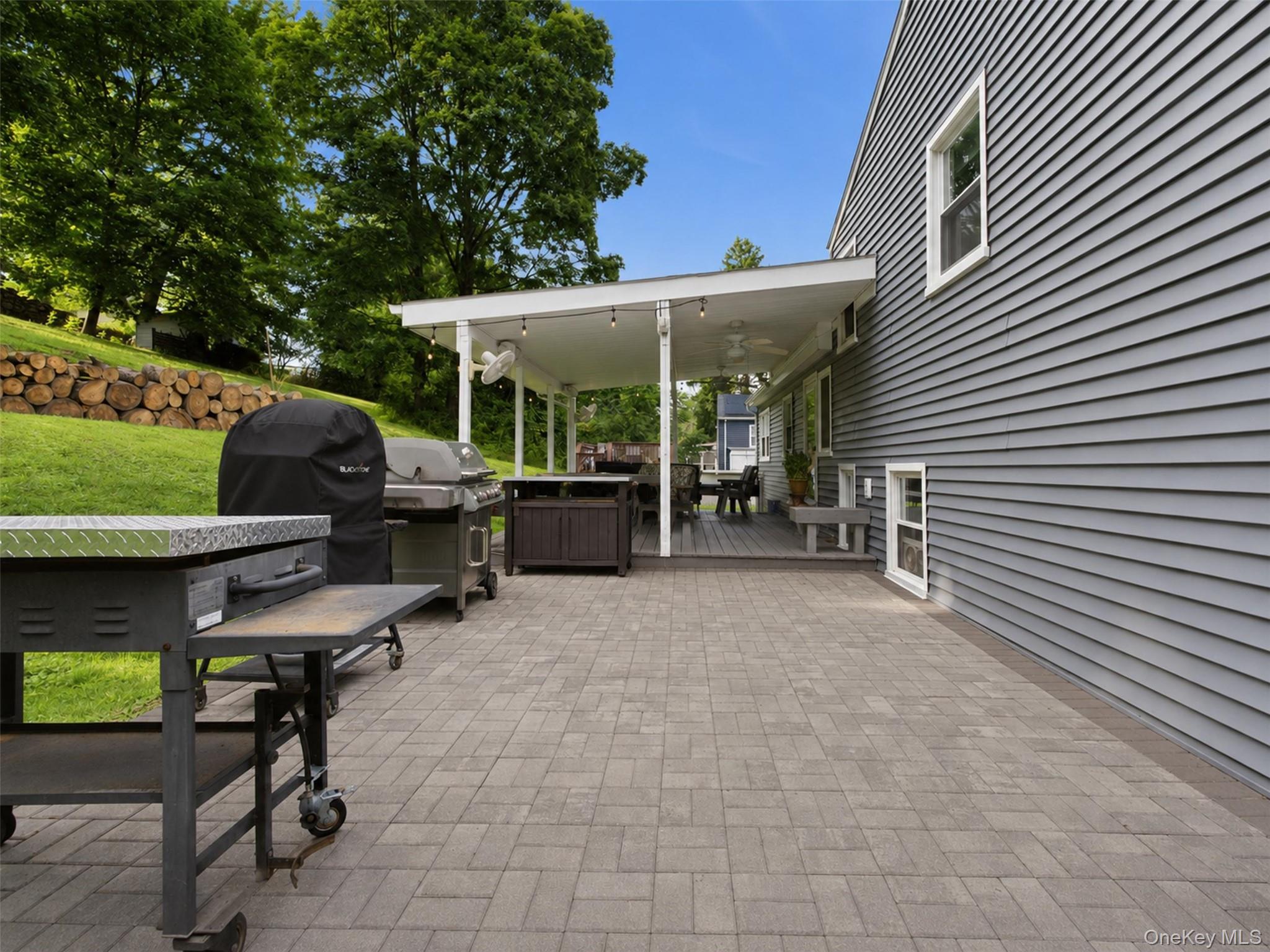617 Cardinal Road Cortlandt Manor, NY 10567 - Photo 24 of 32 Expansive paver patio with a covered deck featuring recessed lighting and ceiling fans