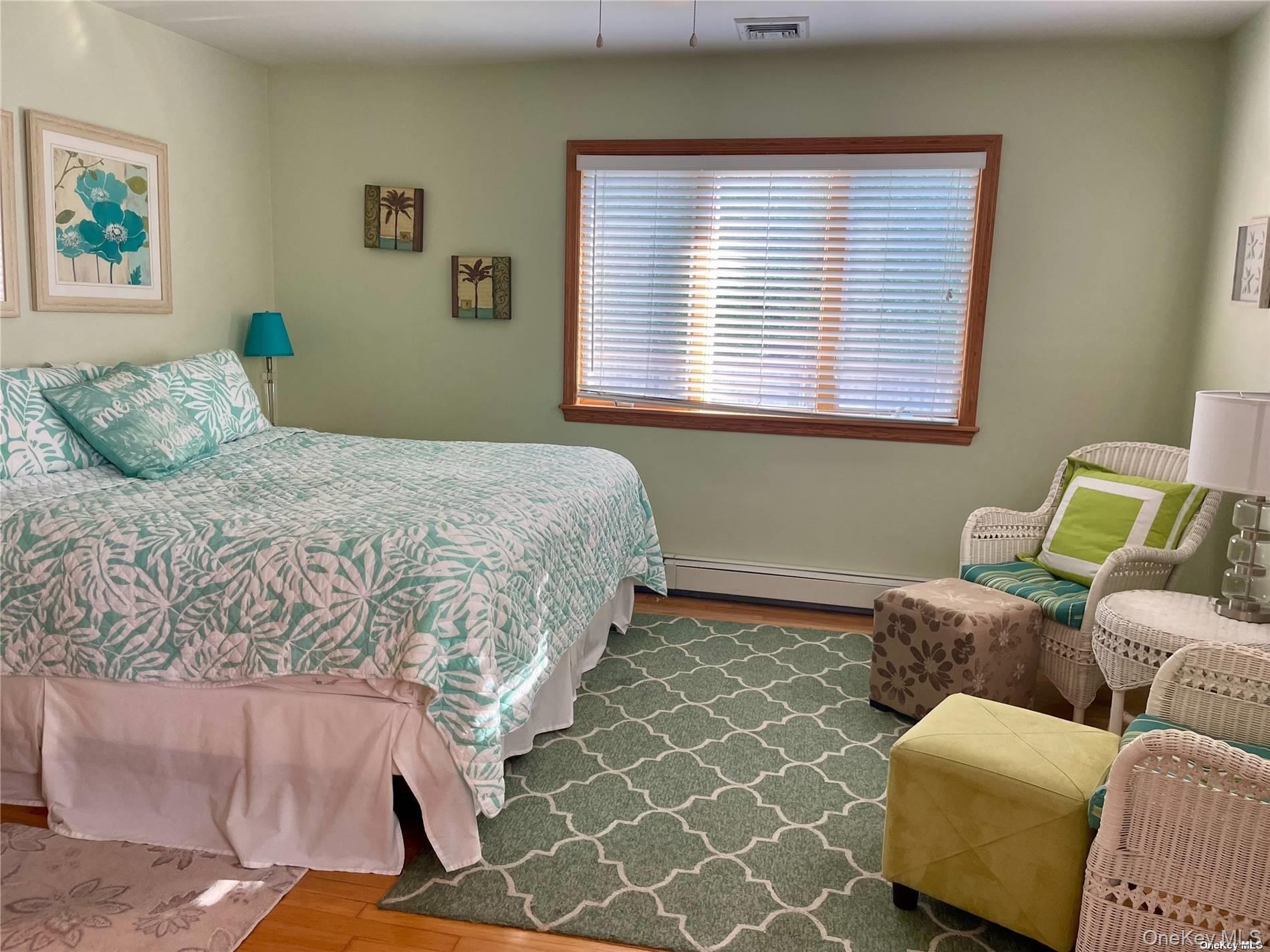 89 Lynbrook Avenue Point Lookout, NY 11569 - Photo 7 of 19 a bedroom with a bed and a window