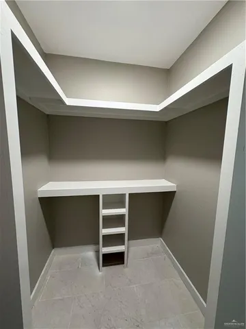 an empty room with wooden floor and a fireplace