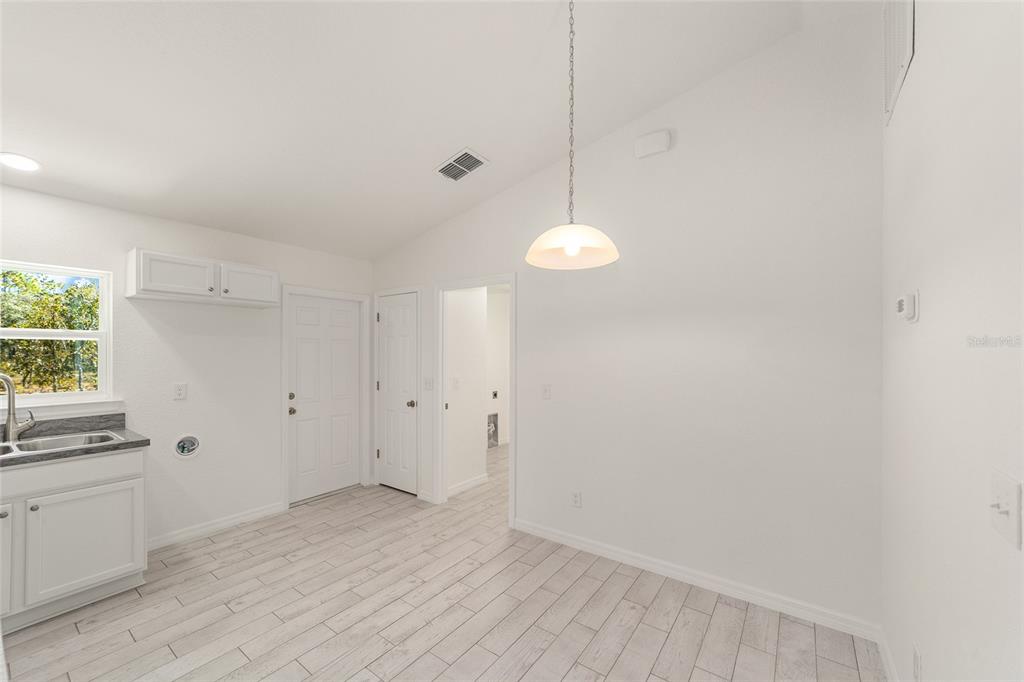 284 Southwest Commodore Road Dunnellon, FL 34431 - Photo 14 of 48 a view of a kitchen with wooden floor and windows