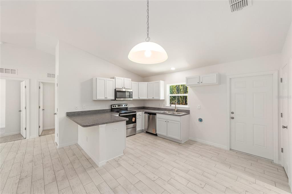 284 Southwest Commodore Road Dunnellon, FL 34431 - Photo 16 of 48 a kitchen with a sink and stove top oven