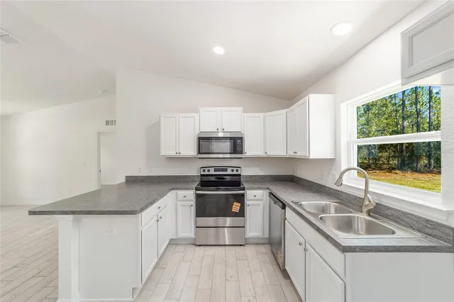 an empty room with a window and wooden floor