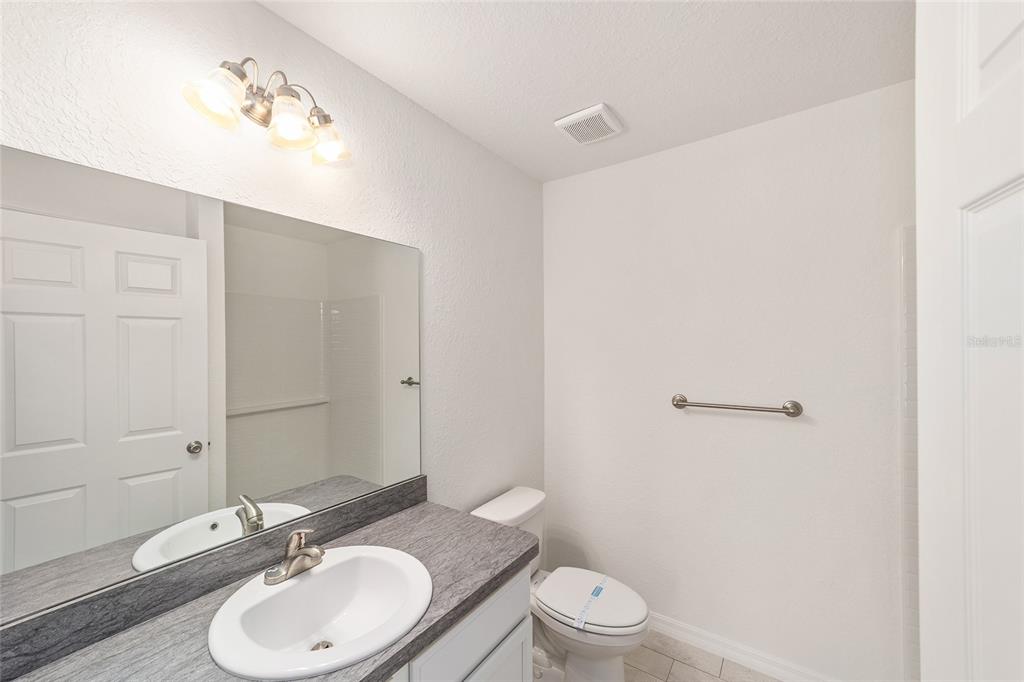 284 Southwest Commodore Road Dunnellon, FL 34431 - Photo 23 of 48 a bathroom with a granite countertop sink toilet a mirror and shower