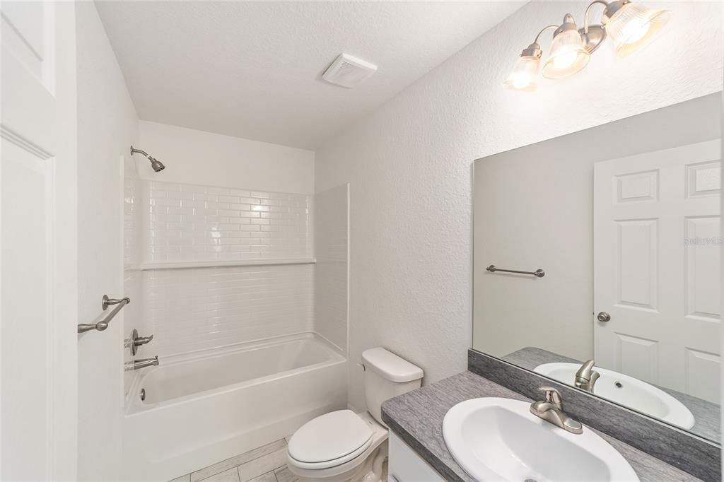 284 Southwest Commodore Road Dunnellon, FL 34431 - Photo 27 of 48 a bathroom with a bathtub shower sink mirror vanity and a toilet