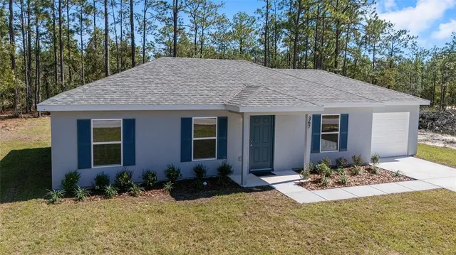 a front view of house with yard outdoor seating and green space
