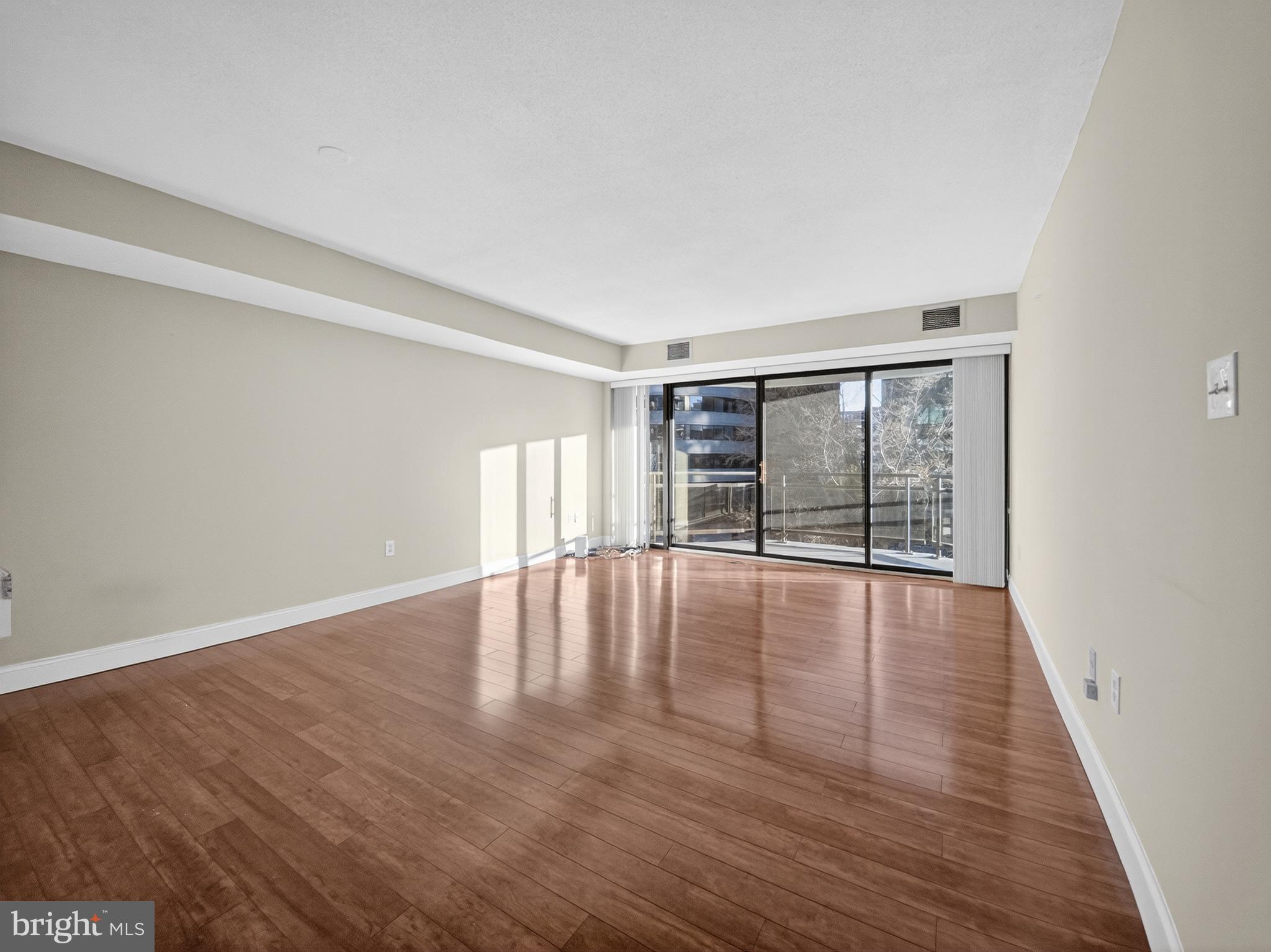 1530 Key Boulevard, Unit 517 Arlington, VA 22209 - Photo 14 of 50 wooden floor in an empty room with a window