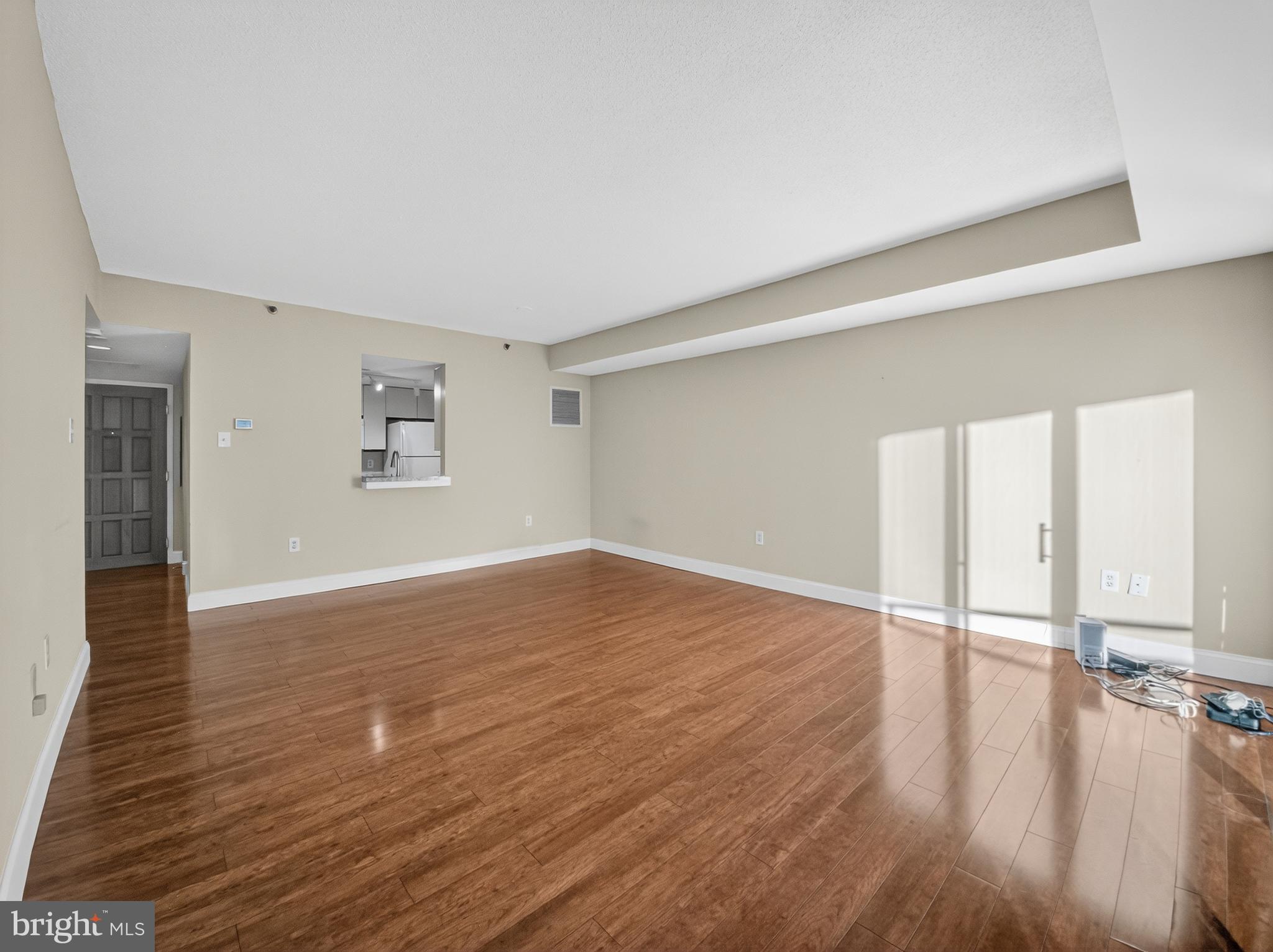 1530 Key Boulevard, Unit 517 Arlington, VA 22209 - Photo 17 of 50 wooden floor in an empty room with a window