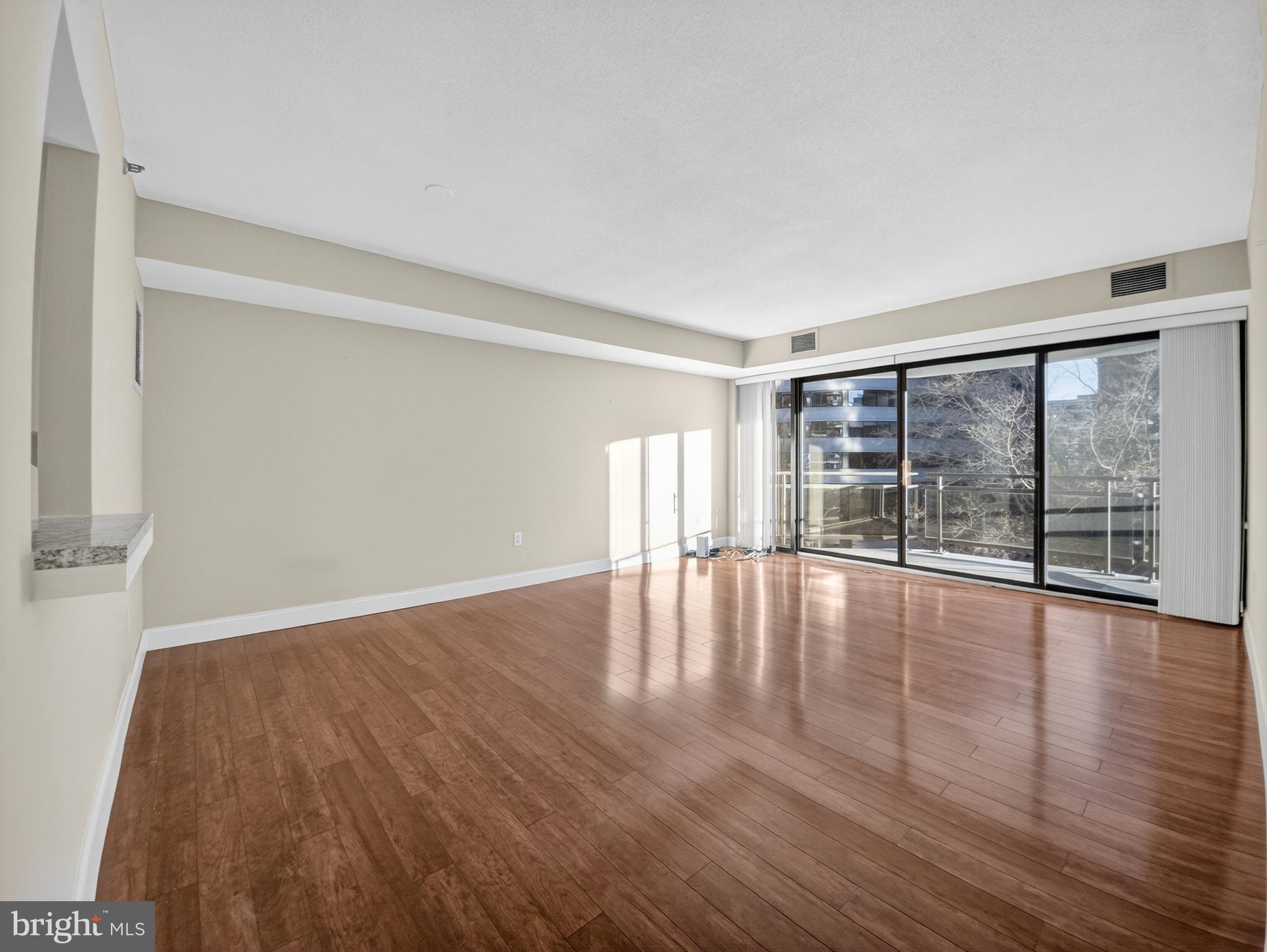 1530 Key Boulevard, Unit 517 Arlington, VA 22209 - Photo 19 of 50 wooden floor in an empty room with a window