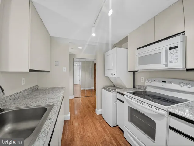 a view of a granite counter top a sink and a window
