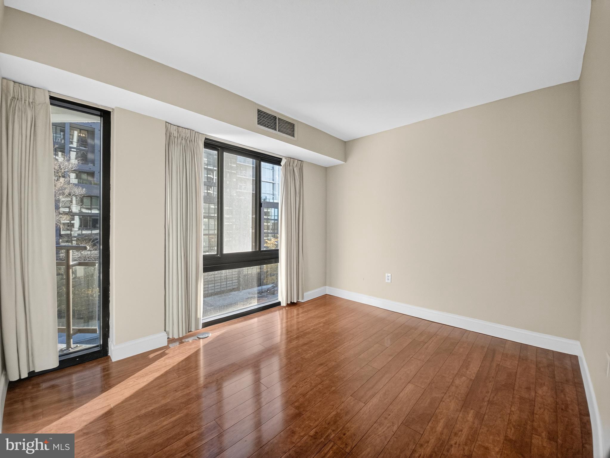 1530 Key Boulevard, Unit 517 Arlington, VA 22209 - Photo 27 of 50 wooden floor in an empty room with a window