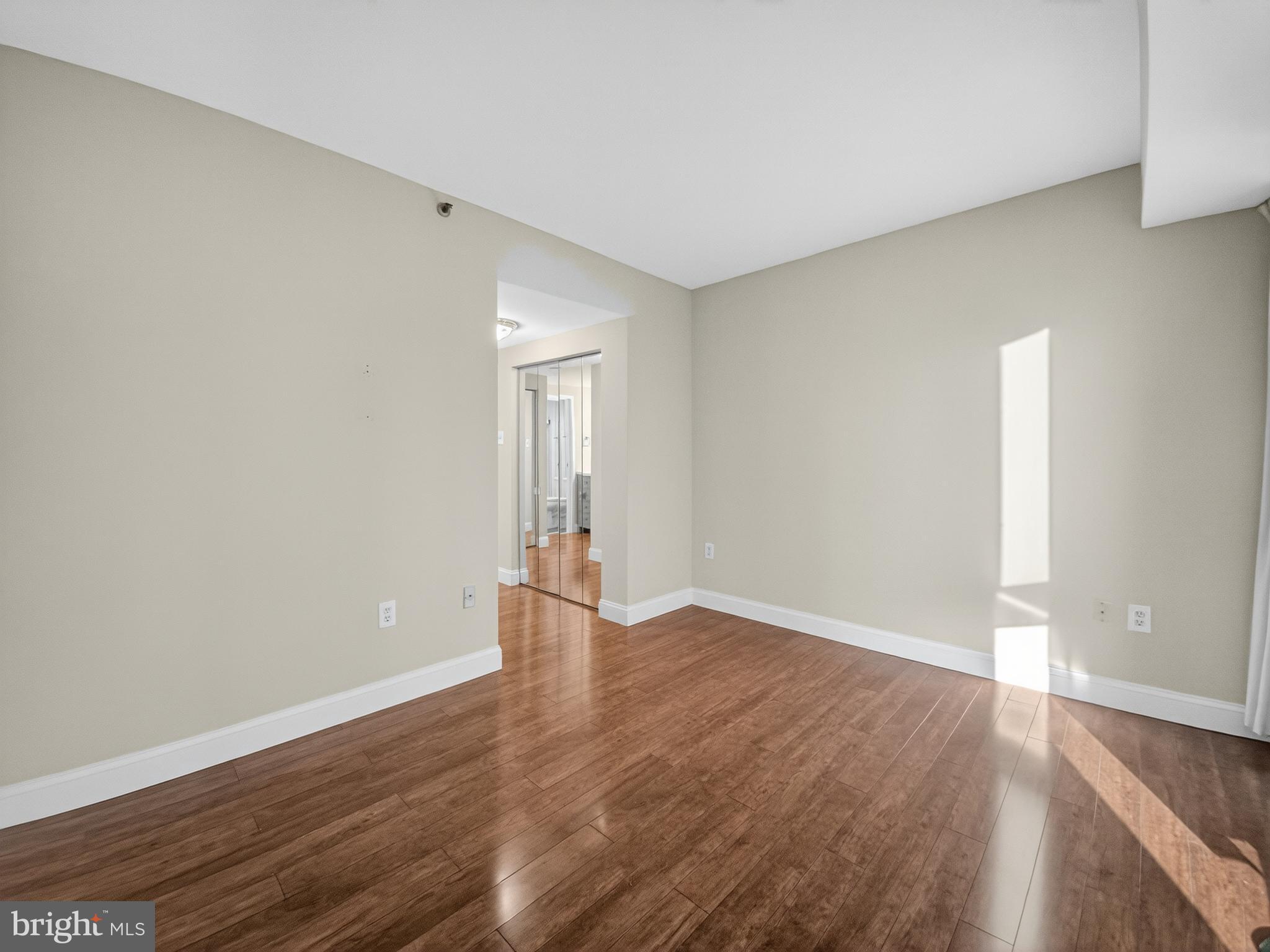 1530 Key Boulevard, Unit 517 Arlington, VA 22209 - Photo 29 of 50 an empty room with wooden floor and windows