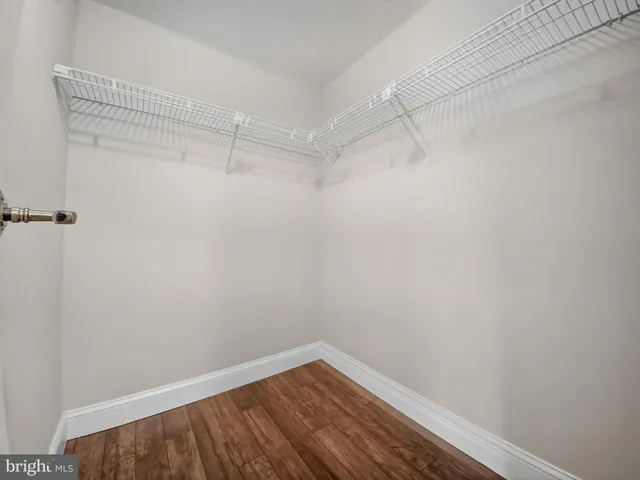 a view of a room with wooden floor and a bathroom
