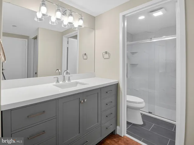 a bathroom with a toilet a sink and a mirror