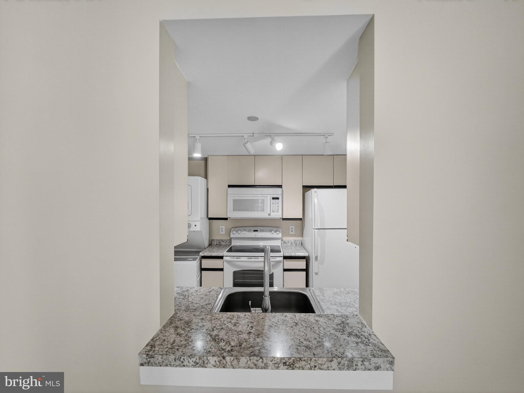 1530 Key Boulevard, Unit 517 Arlington, VA 22209 - Photo 10 of 50 a kitchen with a refrigerator and a counter top space