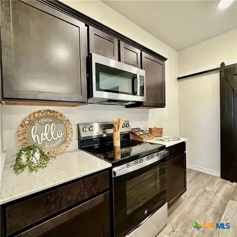 a kitchen with a stove and a microwave