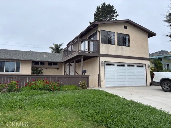 a front view of a house with a garden and garage