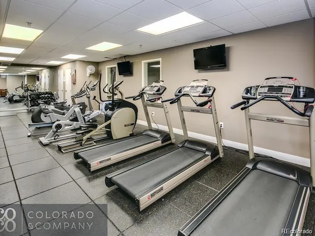 a room with gym equipment and a flat screen tv
