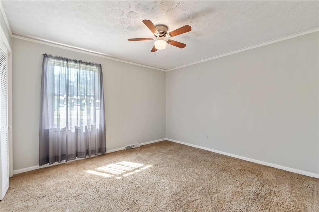 200 Echo Circle Easley, SC 29642 - Photo 19 of 35 A well-lit bedroom offering a cozy retreat with ample natural illumination and soft carpeting.