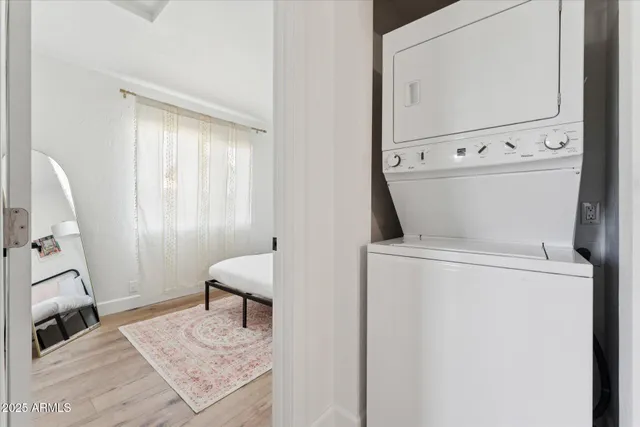 a view of washer and dryer with bathroom in the background