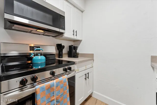 a stove top oven sitting inside of a kitchen