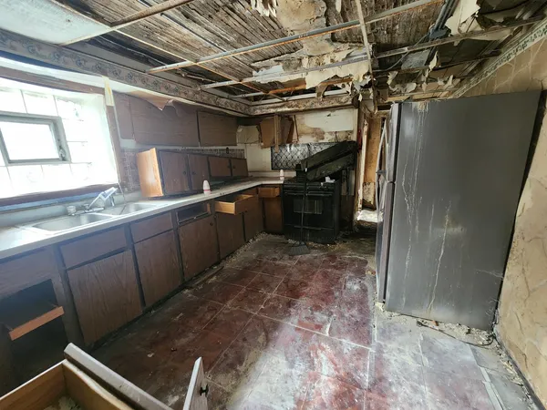 a kitchen with refrigerator and window