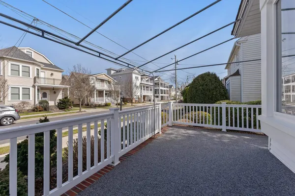 a view of a porch with wooden fence and floor