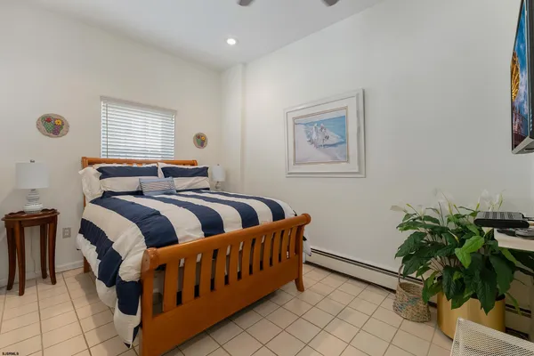 a bedroom with furniture and a potted plant