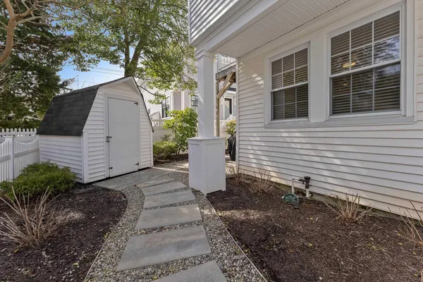 a front view of a house with garden and garage