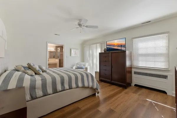 a bedroom with a bed and a television