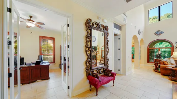 a dining room with furniture a chandelier and window