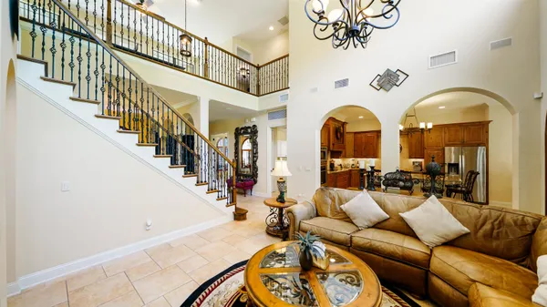 a bedroom with a bed and a chandelier
